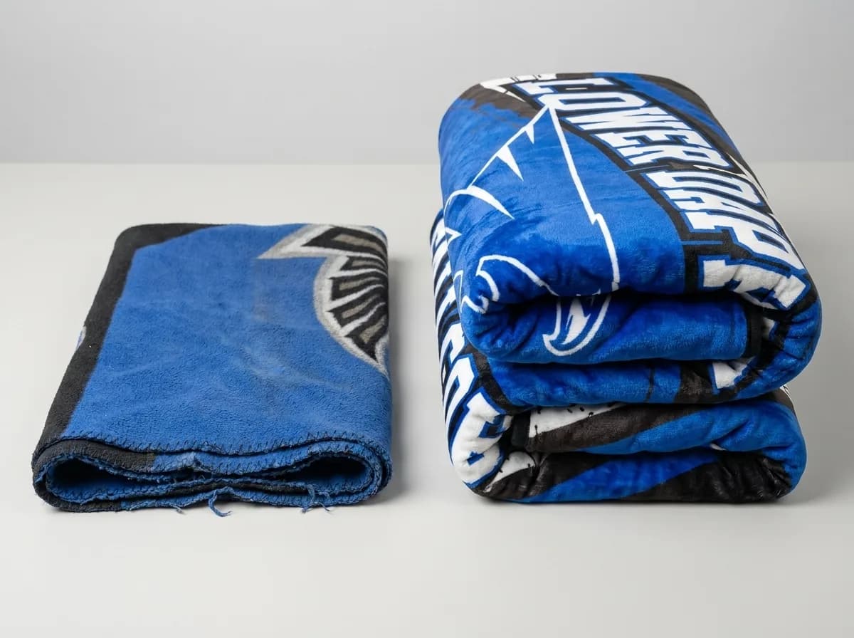 Two folded custom printed blankets compared side by side, showing the sublimated print staying uniform through the fold