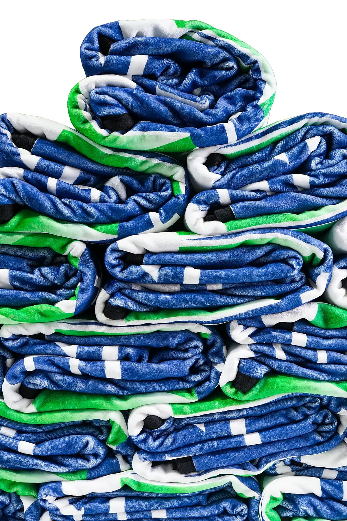 A folded stack of blue, green, and white printed blankets showing saturated color holding across many units